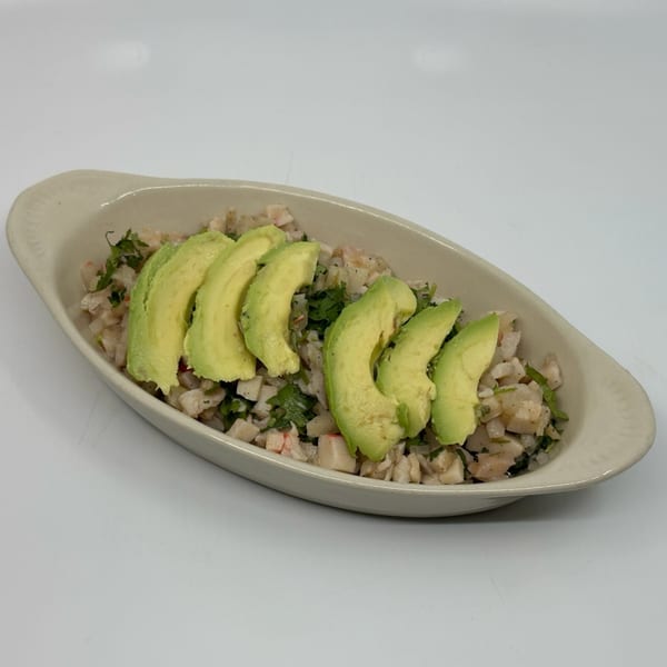 Taqueria Mi Pueblo's ceviche with diced fish, cilantro, and avocado slices in a light bowl.