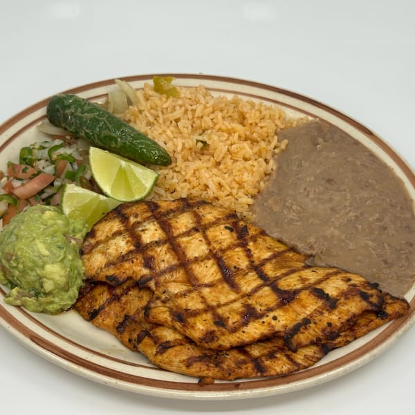 Grilled chicken with rice, refried beans, guacamole, pico de gallo, lime, and a serrano pepper.