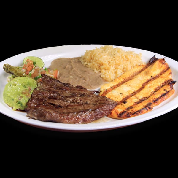 Grilled steak, chicken, rice, refried beans, guacamole, pico de gallo, and a lime wedge.