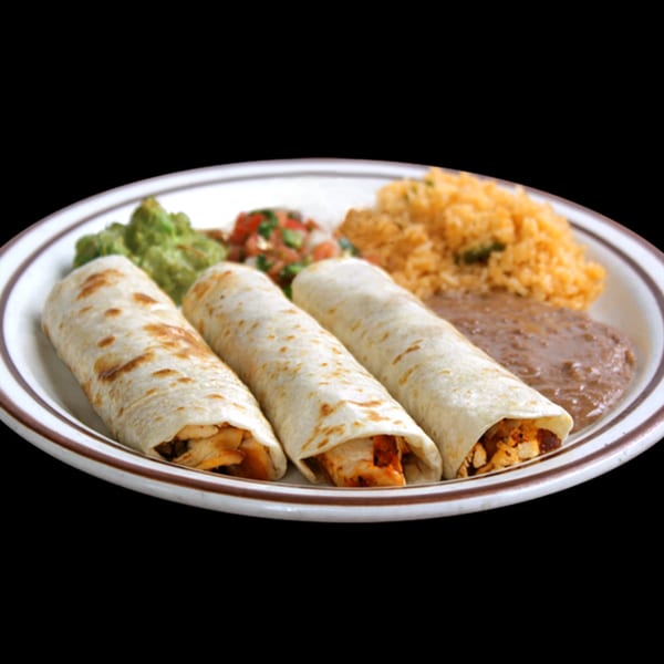 Three chicken flautas with rice, refried beans, guacamole, and pico de gallo on a white plate.